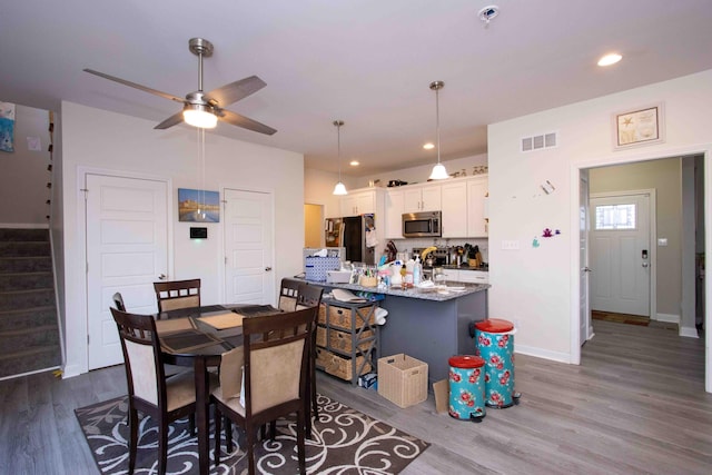 dining room featuring dark hardwood / wood-style floors and ceiling fan