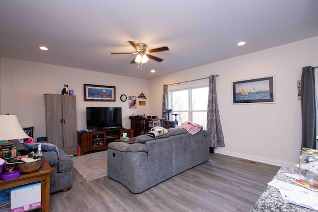 living room featuring ceiling fan and hardwood / wood-style floors