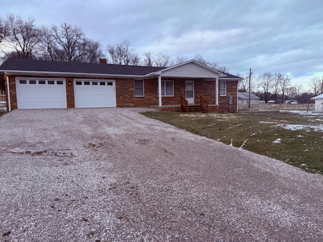 ranch-style home with a garage and a front yard