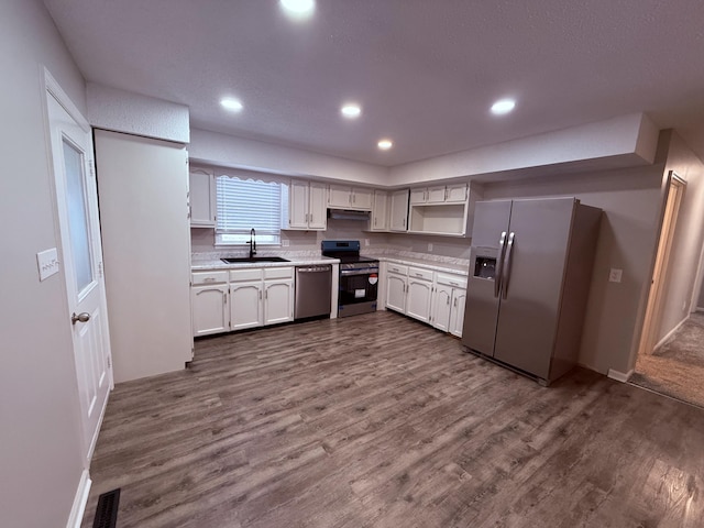 106 Liberty Ave, Berea, KY 40403 - kitchen with light countertops, visible vents, appliances with stainless steel finishes, a sink, and dark wood-style floors