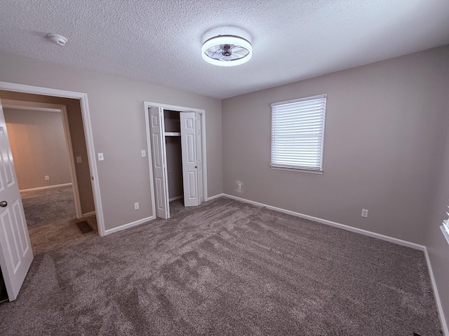 106 Liberty Ave, Berea, KY 40403 - unfurnished bedroom featuring a closet, a textured ceiling, baseboards, visible vents, and carpet