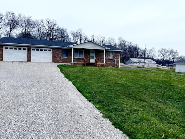 106 Liberty Ave, Berea, KY 40403 - ranch-style house featuring fence, gravel driveway, a garage, a front yard, and brick siding