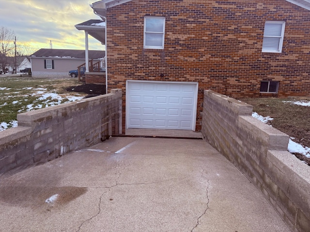 106 Liberty Ave, Berea, KY 40403 - view of side of property with brick siding, driveway, and an attached garage