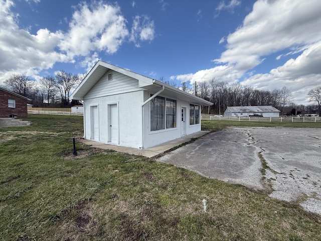 106 Liberty Ave, Berea, KY 40403 - view of side of property with concrete block siding, fence, and a lawn