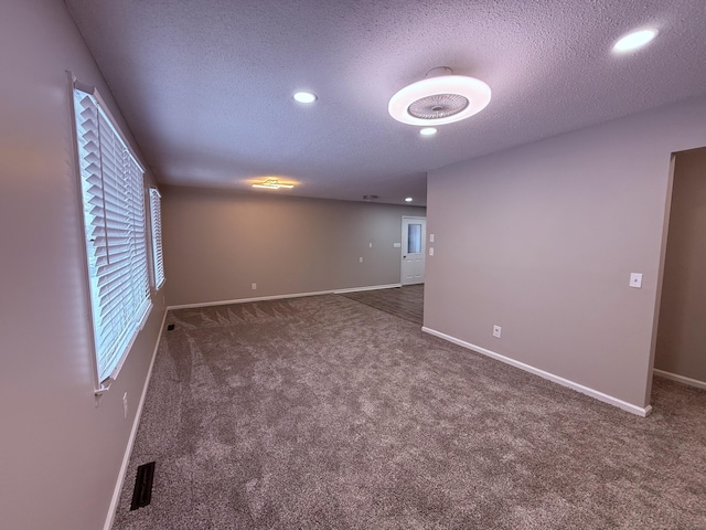 106 Liberty Ave, Berea, KY 40403 - spare room with baseboards, visible vents, carpet, and a textured ceiling