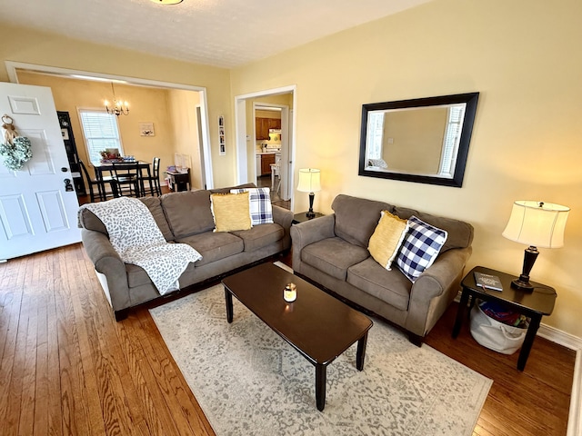 living room featuring hardwood / wood-style flooring and a chandelier