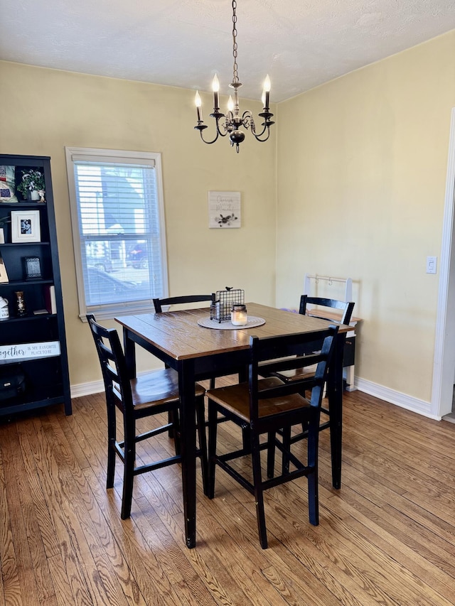 dining room featuring a notable chandelier and hardwood / wood-style flooring