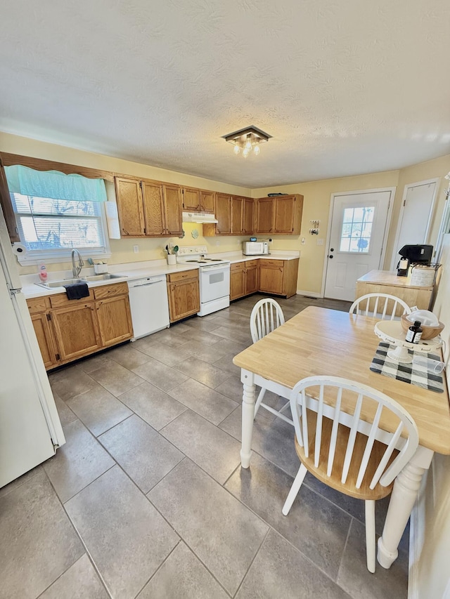 428 Columbia Ave, Monticello, KY 42633 - kitchen with a sink, under cabinet range hood, light tile patterned flooring, white appliances, and light countertops