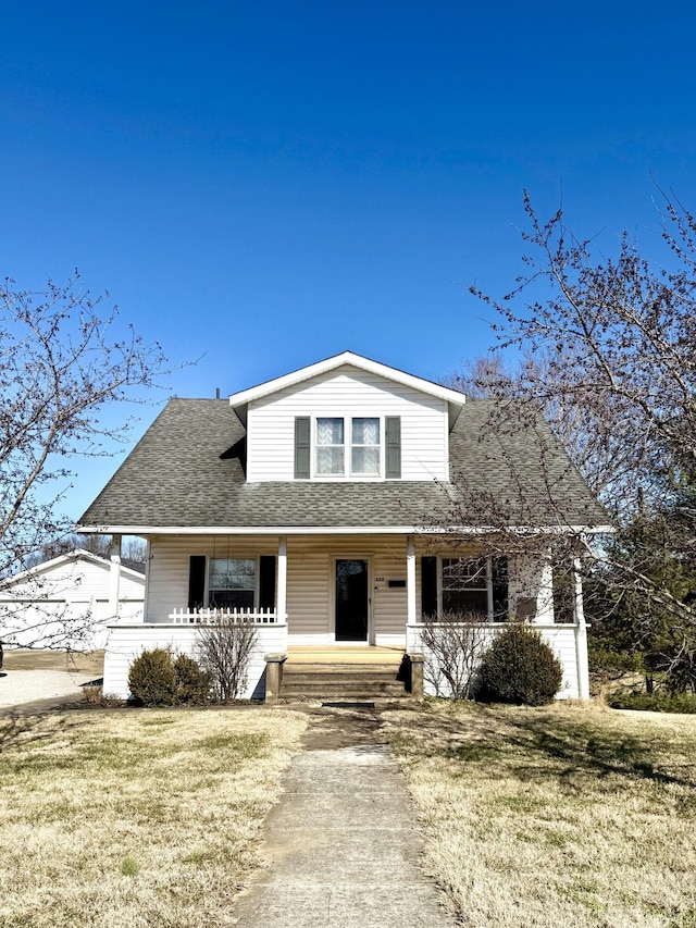 view of front facade with covered porch and a front lawn