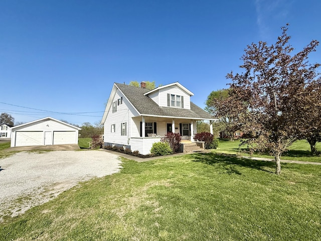 428 Columbia Ave, Monticello, KY 42633 - cape cod-style house featuring a chimney, an outbuilding, a front yard, a porch, and a garage