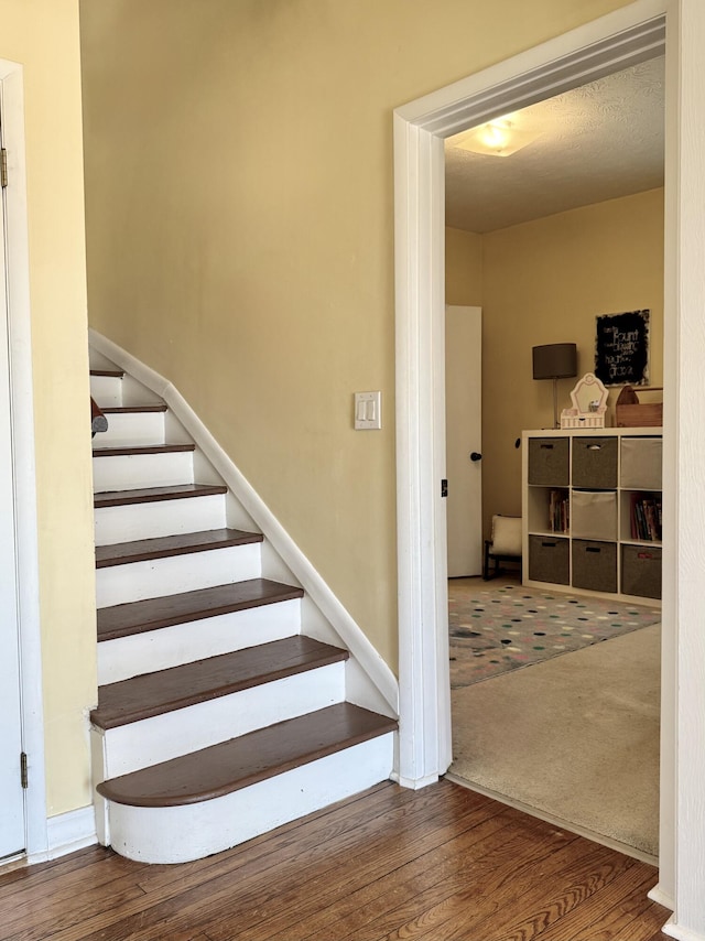 stairway featuring hardwood / wood-style floors