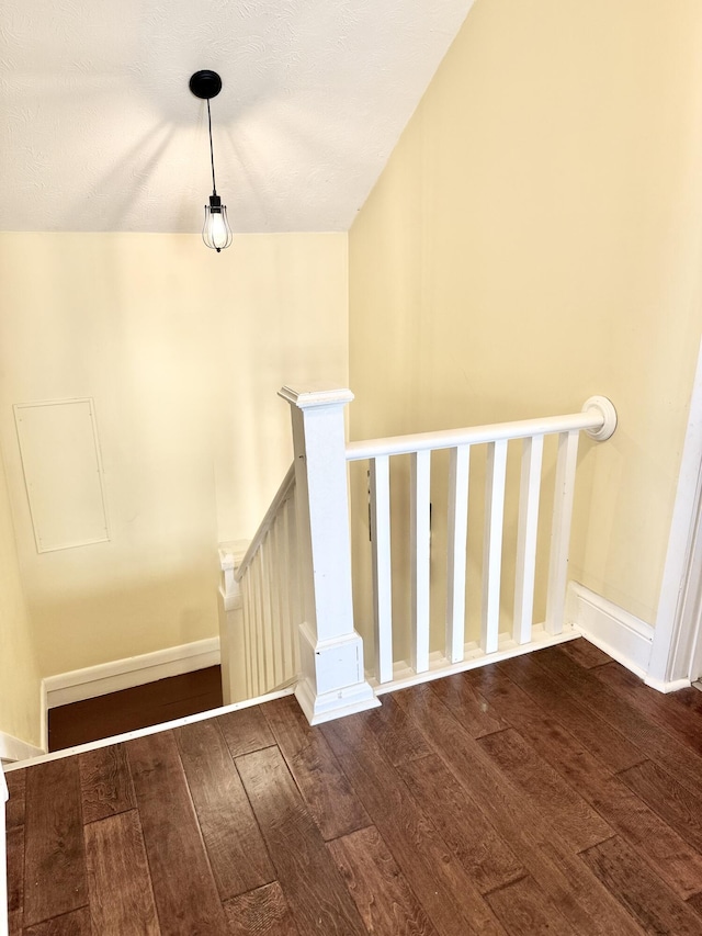 stairs featuring hardwood / wood-style floors