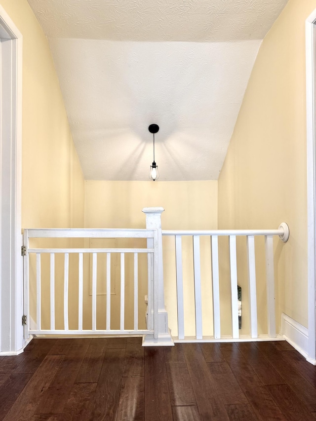 corridor with hardwood / wood-style flooring