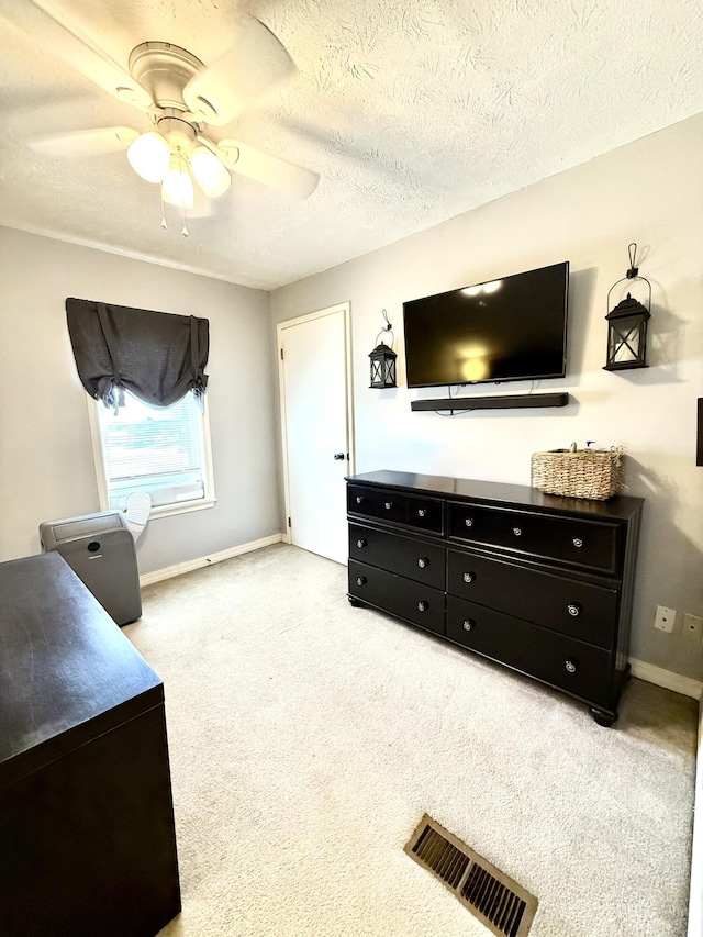 living room with ceiling fan and a textured ceiling