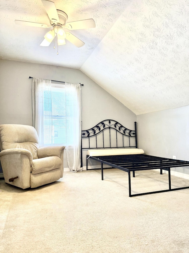 carpeted bedroom featuring ceiling fan, lofted ceiling, and a textured ceiling