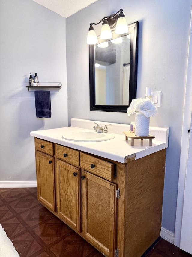 bathroom with vanity and parquet floors