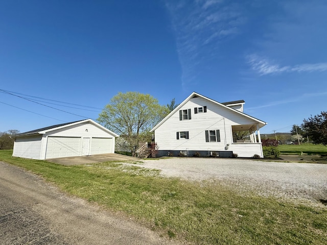 428 Columbia Ave, Monticello, KY 42633 - view of side of property featuring an outbuilding, a detached garage, and a lawn