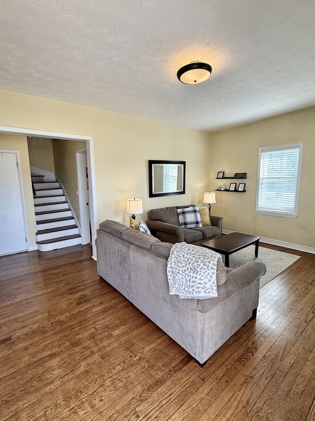 living room featuring hardwood / wood-style flooring and a textured ceiling