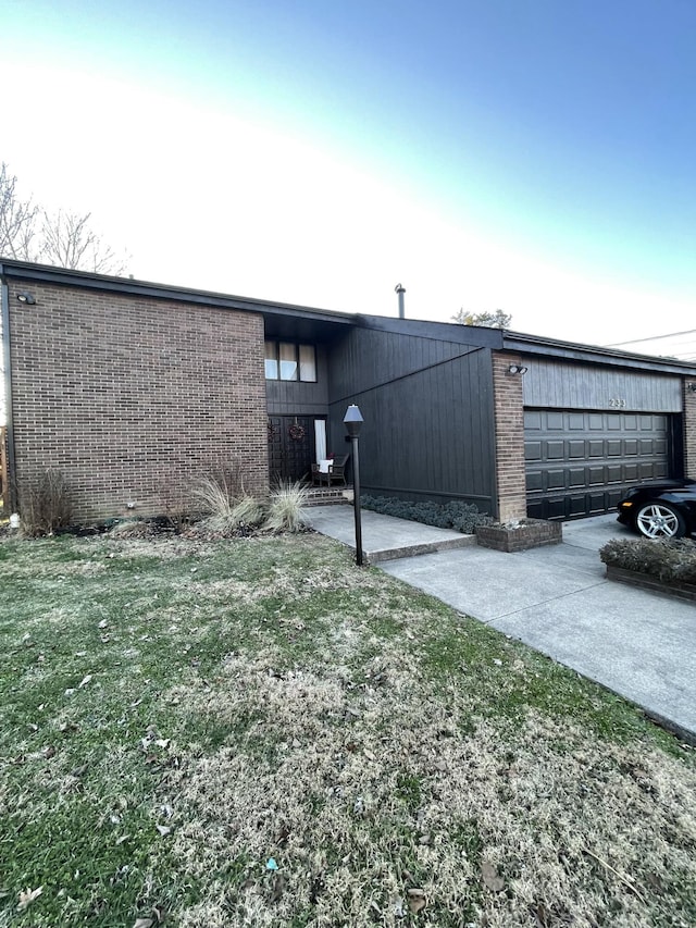 view of home's exterior with a garage and a lawn