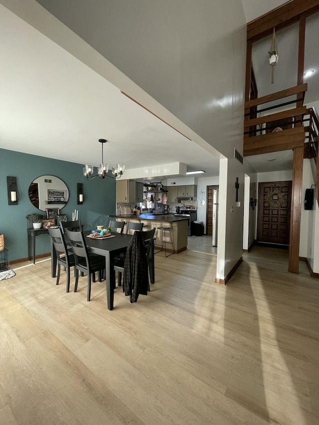 dining space featuring a notable chandelier and light hardwood / wood-style floors