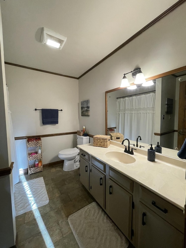 bathroom with vanity, ornamental molding, and toilet