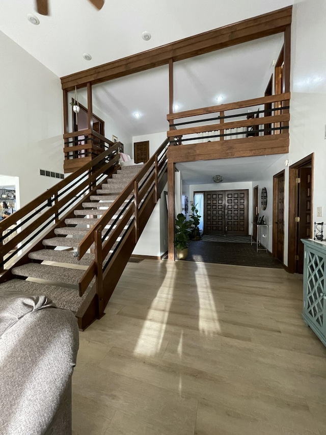 stairs featuring a high ceiling