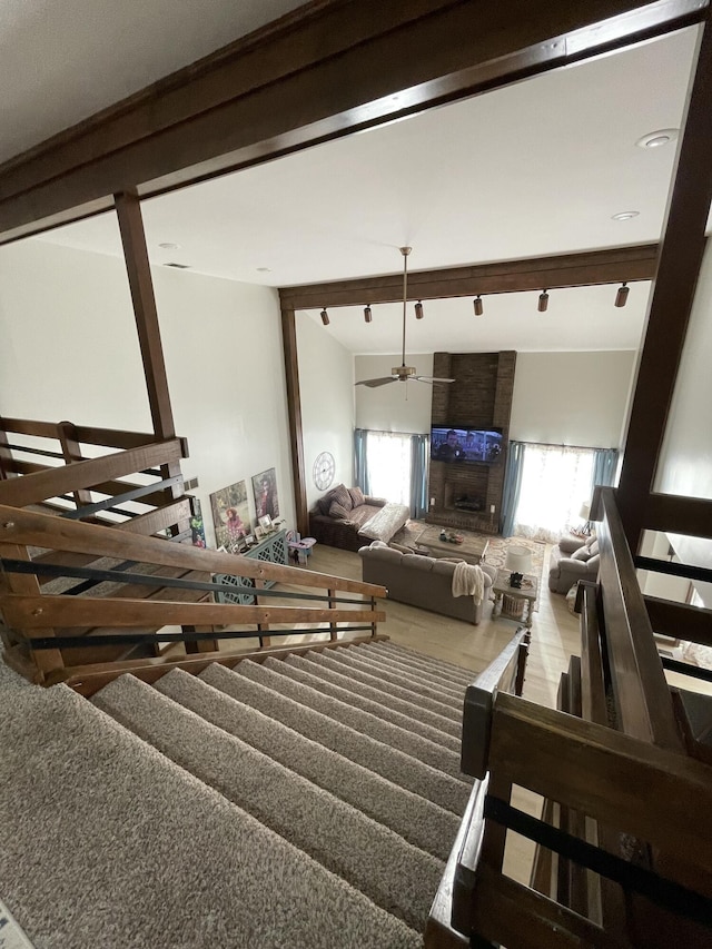 living room with beamed ceiling and a healthy amount of sunlight