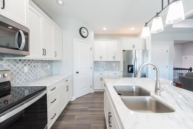 kitchen featuring dark wood-style floors, white cabinetry, appliances with stainless steel finishes, and a sink