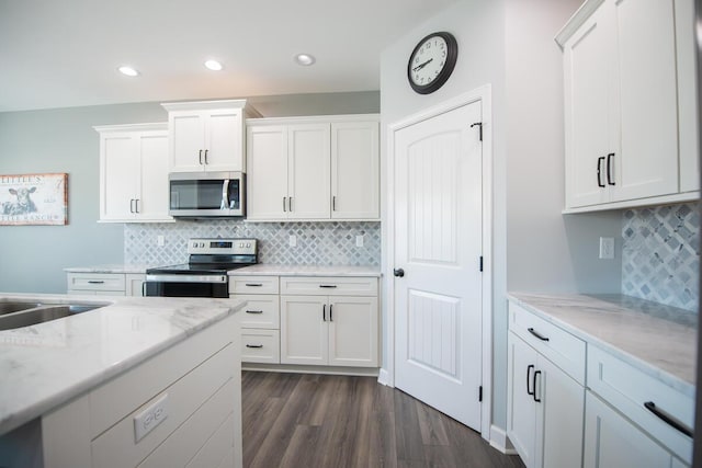 kitchen featuring stainless steel appliances, dark wood-type flooring, and white cabinets