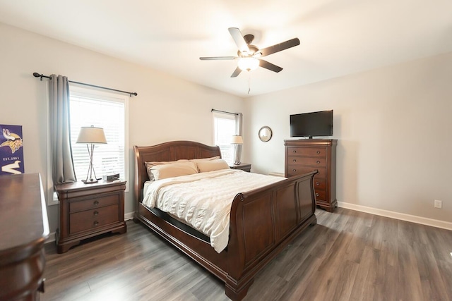 bedroom featuring dark wood-style floors, ceiling fan, and baseboards