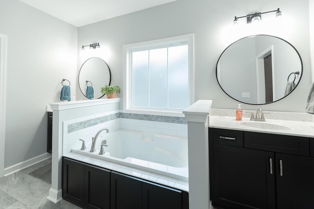 bathroom with vanity, baseboards, and a bath