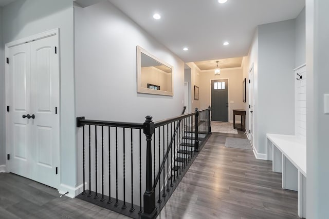 corridor featuring crown molding, baseboards, dark wood-style flooring, and recessed lighting