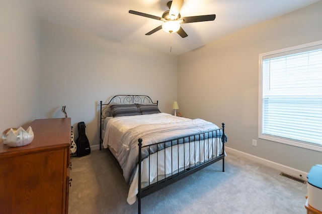 bedroom featuring carpet floors, a ceiling fan, visible vents, and baseboards