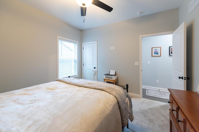 bedroom with carpet floors, baseboards, visible vents, and ceiling fan