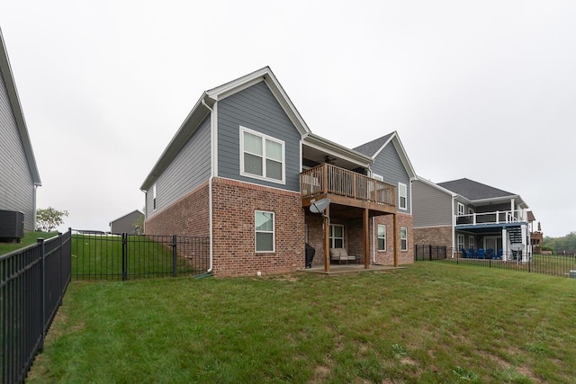 back of house with a patio area, brick siding, a yard, and a fenced backyard