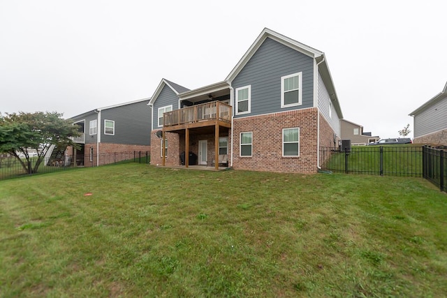 back of house featuring a patio area, brick siding, a lawn, and a fenced backyard