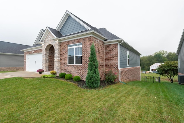 view of front facade with brick siding, an attached garage, a front yard, fence, and driveway