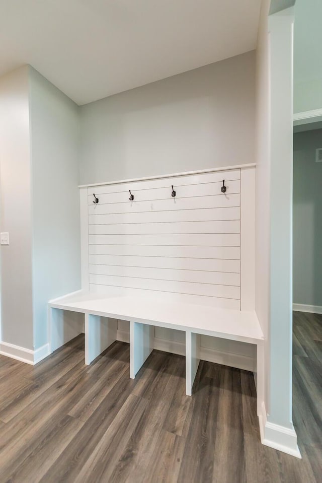 mudroom featuring dark wood-style floors and baseboards