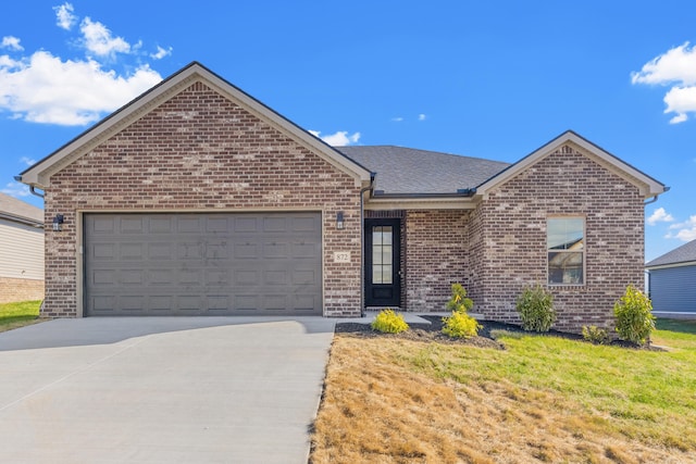 view of front facade with a garage and a front lawn