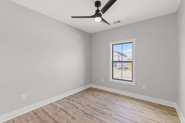 empty room featuring ceiling fan and light hardwood / wood-style floors