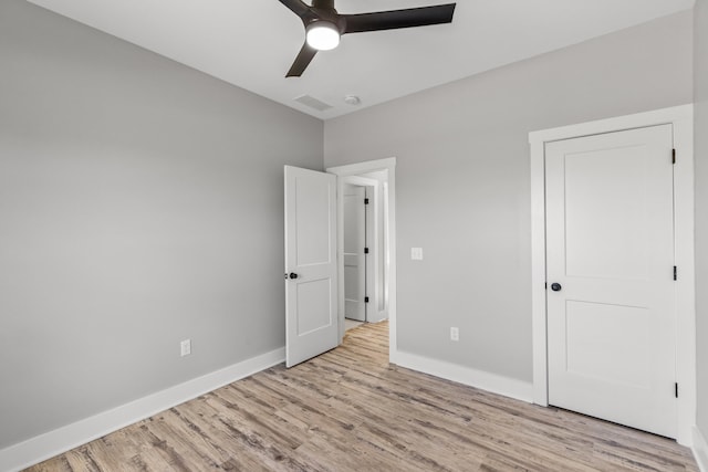 unfurnished bedroom with ceiling fan and light hardwood / wood-style floors