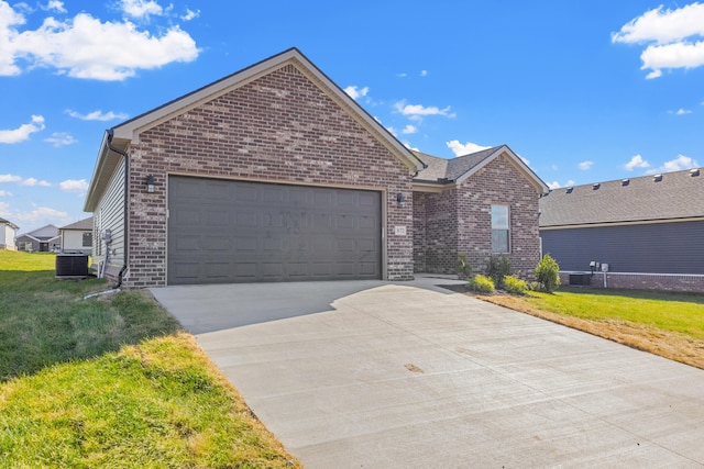 view of front of house with cooling unit, a garage, and a front lawn