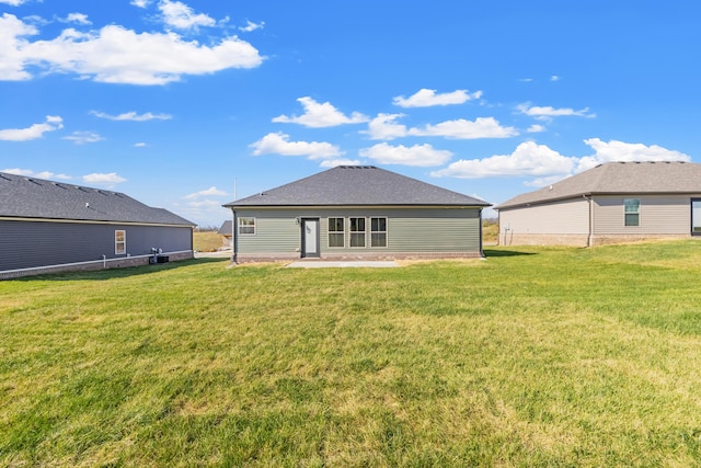 back of property featuring a yard and a patio area