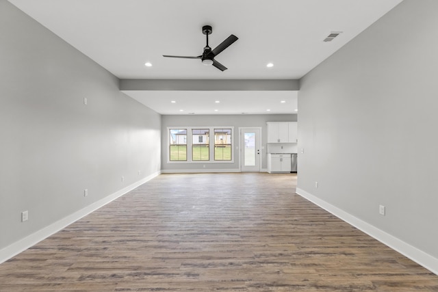 unfurnished living room with hardwood / wood-style flooring and ceiling fan