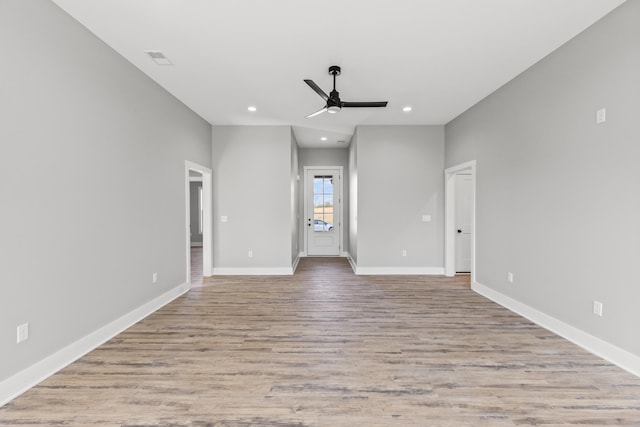 unfurnished living room with ceiling fan and light hardwood / wood-style floors