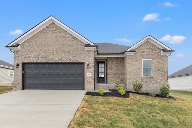 view of front of home featuring a garage and a front yard