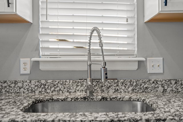 room details with white cabinetry and sink