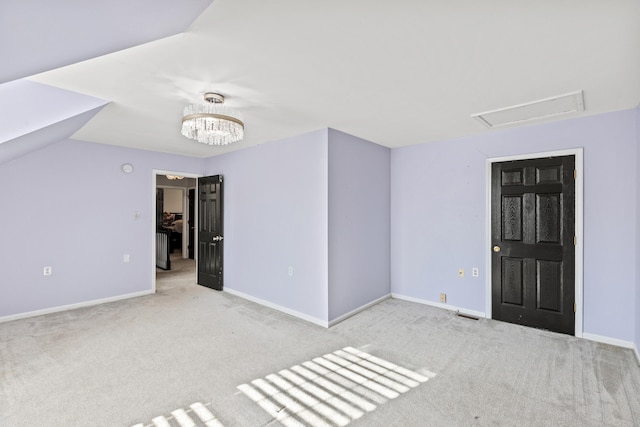 interior space with light carpet and vaulted ceiling