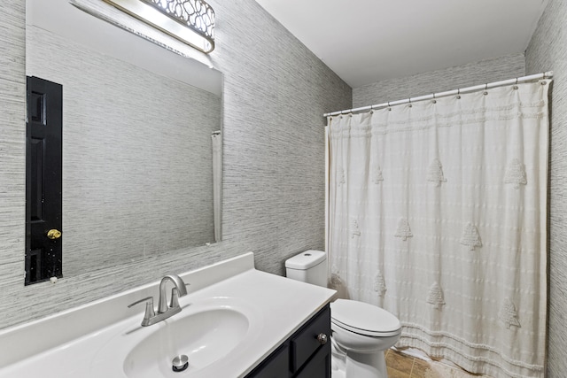 bathroom featuring vanity, toilet, and a shower with shower curtain