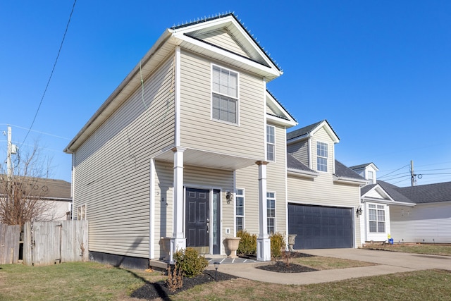 view of property with a garage and a front lawn